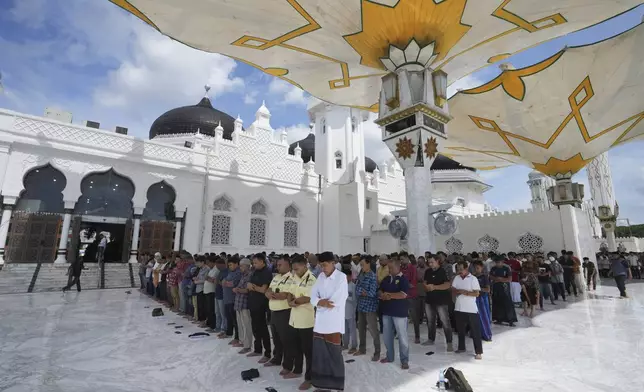 People perform a Friday prayer at Baiturrahman Grand Mosque in Banda Aceh, Indonesia, Friday, Dec. 13, 2024. (AP Photo/Achmad Ibrahim)