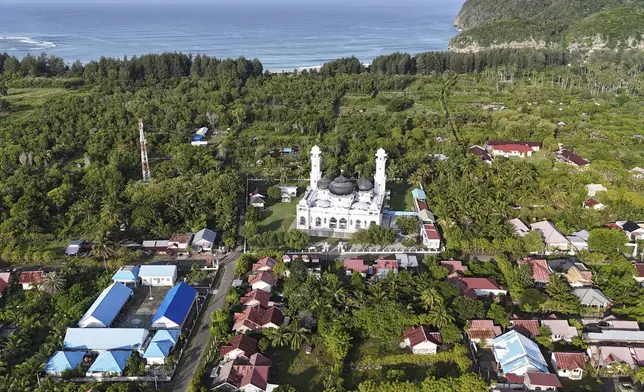 This aerial shot taken using a drone shows Rahmatullah Mosque in Lampuuk village, one of the areas hardest hit by Indian Ocean tsunami in 2004, in Aceh Besar, Indonesia, Thursday, Dec. 12, 2024. (AP Photo/Achmad Ibrahim)