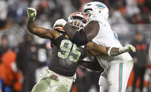 Cleveland Browns defensive end Myles Garrett (95) is pressured by Miami Dolphins offensive tackle Patrick Paul, right, during the second half of an NFL football game Sunday, Dec. 29, 2024, in Cleveland. (AP Photo/David Richard)