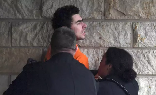 Luigi Nicholas Mangione is escorted into Blair County Courthouse, Tuesday, Dec. 10, 2024, in Hollidaysburg, Pa. (AP Photo/Gary M. Baranec)