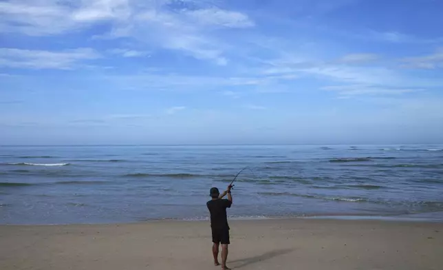 People fish at Ban Nam Khem Beach, where tsunami hit 2004, Takuapa district of Phang Nga province, southern Thailand, Monday, Dec. 9, 2024. (AP Photo/Sakchai Lalit)