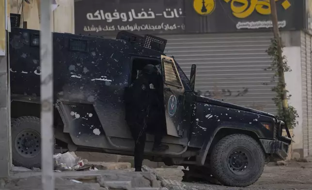 Armored Palestinian security vehicles are seen on the road as Palestinian forces mount a major raid against militants in the Jenin refugee camp in the Israeli-occupied West Bank, Monday, Dec. 23, 2024. (AP Photo/Majdi Mohammed)