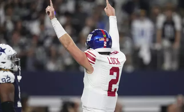 New York Giants quarterback Drew Lock (2) celebrates after running back Tyrone Tracy Jr. (29) scored a touchdown against the Dallas Cowboys during the first half of an NFL football game in Arlington, Texas, Thursday, Nov. 28, 2024. (AP Photo/Tony Gutierrez)