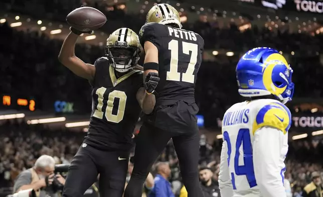 New Orleans Saints wide receiver Marquez Valdes-Scantling (10) celebrates his touchdown catch with wide receiver Dante Pettis (17) during the second half of an NFL football game against the Los Angeles Rams, Sunday, Dec. 1, 2024, in New Orleans. (AP Photo/Gerald Herbert)