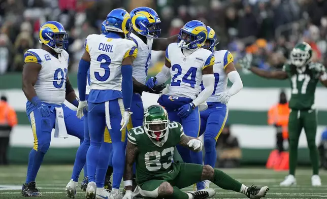 Los Angeles Rams cornerback Darious Williams (24) celebrates with teammates over New York Jets tight end Tyler Conklin (83) during the second half of an NFL football game in East Rutherford, N.J., Sunday, Dec. 22, 2024. (AP Photo/Julia Demaree Nikhinson)