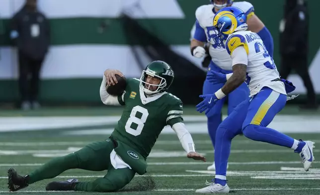 New York Jets quarterback Aaron Rodgers (8) slides in front of Los Angeles Rams safety Jaylen McCollough during the second half of an NFL football game in East Rutherford, N.J., Sunday, Dec. 22, 2024. (AP Photo/Seth Wenig)