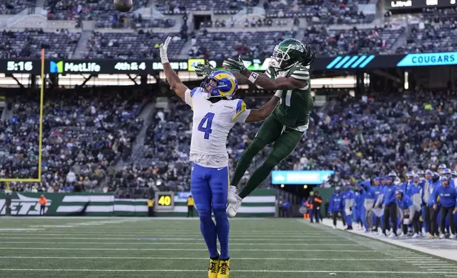 Los Angeles Rams cornerback Ahkello Witherspoon (4) breaks up a pass intended for New York Jets wide receiver Davante Adams during the second half of an NFL football game in East Rutherford, N.J., Sunday, Dec. 22, 2024. (AP Photo/Julia Demaree Nikhinson)