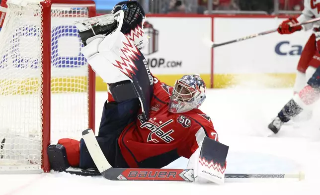 Washington Capitals goaltender Charlie Lindgren saves the puck during the second period of an NHL hockey game against the Carolina Hurricanes, Friday, Dec. 20, 2024, in Washington. (AP Photo/Nick Wass)