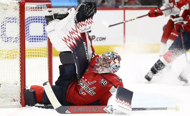 Washington Capitals goaltender Charlie Lindgren saves the puck during the second period of an NHL hockey game against the Carolina Hurricanes, Friday, Dec. 20, 2024, in Washington. (AP Photo/Nick Wass)