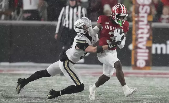 FILE - Indiana wide receiver Omar Cooper Jr. (3) is tackled by Purdue defensive back Dillon Thieneman (31) during the first half of an NCAA college football game, Saturday, Nov. 30, 2024, in Bloomington, Ind. (AP Photo/Darron Cummings, File)