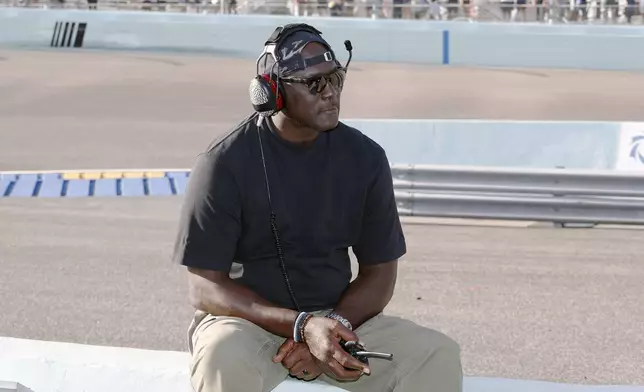 FILE - Car owner Michael Jordan watches from the pits during a NASCAR Cup Series auto race at Homestead-Miami Speedway in Homestead, Fla., Oct. 27, 2024. (AP Photo/Terry Renna, File)