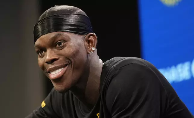 Golden State Warriors guard Dennis Schroder speaks at a news conference at the NBA basketball team's facility in San Francisco, Tuesday, Dec. 17, 2024. (AP Photo/Jeff Chiu)