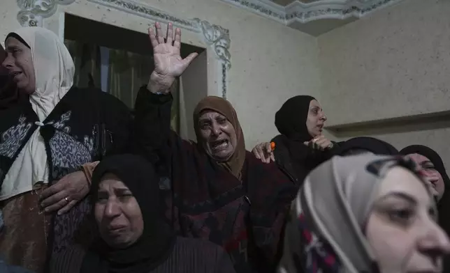 Mourners cry while they take the last look at the body of Palestinian Zein Atatrah, 18, during his funeral in the West Bank town of Ya'bad, Friday, Dec. 27, 2024. (AP Photo/Nasser Nasser)