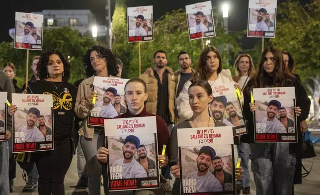 Supporters, some twins, and the family members of twin brothers, Ziv and Gali Berman, who are held by Hamas in Gaza, gathered in Tel Aviv, Israel to call for their release , Thursday, Dec. 26, 2024. (AP Photo/Ohad Zwigenberg)