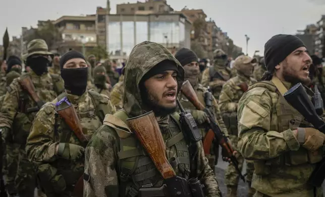 Members of the new armed forces, former rebels who overthrew Bashar Assad's government and now serve in the new Syrian government, stand in formation before a military parade in downtown Damascus, Syria, Friday, Dec. 27, 2024. (AP Photo/Leo Correa)