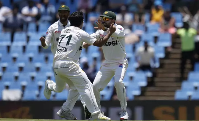 Pakistan's Naseem Shah, front, celebrates with his teammates after bowling out South Africa's Kyle Verreynne for 2 runs during day four of the Test cricket match between South Africa and Pakistan, at the Centurion Park in Centurion, South Africa, Sunday, Dec. 29, 2024. (AP Photo/Themba Hadebe)