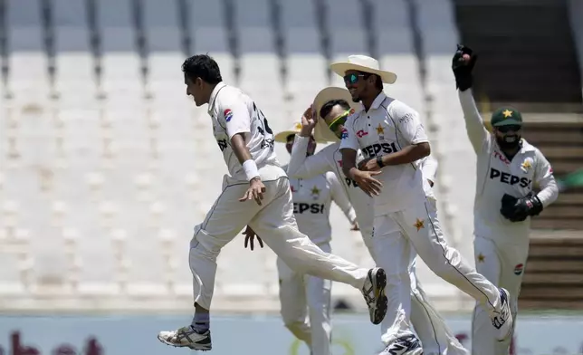 Pakistan's Mohammad Abbas, left, celebrates with his teammates after dismissing South Africa's David Bedingham for 14 runs during day four of the Test cricket match between South Africa and Pakistan, at the Centurion Park in Centurion, South Africa, Sunday, Dec. 29, 2024. (AP Photo/Themba Hadebe)