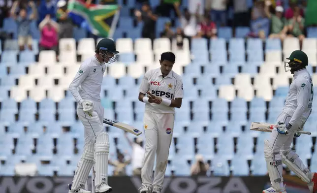 South Africa's Marco Jansen, left, celebrates teammate Kagiso Rabada, right, after scoring the winning runs following the day four of the Test cricket match between South Africa and Pakistan, at the Centurion Park in Centurion, South Africa, Sunday, Dec. 29, 2024. (AP Photo/Themba Hadebe)