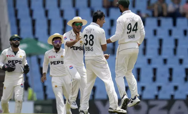 Pakistan's Mohammad Abbas, center, celebrates with his teammates after dismissing South Africa's Aiden Markam 37 runs during day four of the Test cricket match between South Africa and Pakistan, at the Centurion Park in Centurion, South Africa, Sunday, Dec. 29, 2024. (AP Photo/Themba Hadebe)