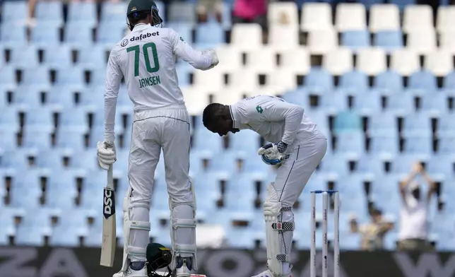 South Africa's Marco Jansen, left, celebrates teammate Kagiso Rabada, after scoring the winning runs following the day four of the Test cricket match between South Africa and Pakistan, at the Centurion Park in Centurion, South Africa, Sunday, Dec. 29, 2024. (AP Photo/Themba Hadebe)