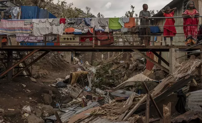 Debris litters a stream in the Kaweni slum in the French Indian Ocean island of Mayotte, Thursday, Dec. 19, 2024, after Cyclone Chido.. (AP Photo/Adrienne Surprenant))