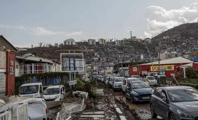 Cars are stopped in a traffic jam in Mamoudzou, Mayotte, Tuesday, Dec. 19, 2024. (AP Photo/Adrienne Surprenant)