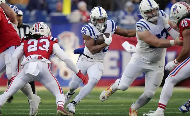 Indianapolis Colts running back Jonathan Taylor (28) carries the ball against New England Patriots safety Kyle Dugger (23) during the second half of an NFL football game, Sunday, Dec. 1, 2024, in Foxborough, Mass. (AP Photo/Steven Senne)