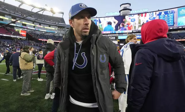 Indianapolis Colts head coach Shane Steichen, center, walks on the field after his team defeated the New England Patriots in an NFL football game, Sunday, Dec. 1, 2024, in Foxborough, Mass. (AP Photo/Steven Senne)