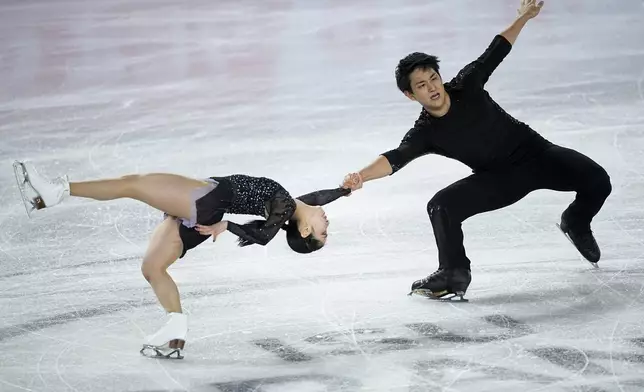 Riku Miura and Ryuichi Kihara, of Japan, compete in the pairs' short program segment at the ISU Grand Prix Finals of Figure Skating, Thursday, Dec. 5, 2024, in Grenoble, France. (AP Photo/Laurent Cipriani)