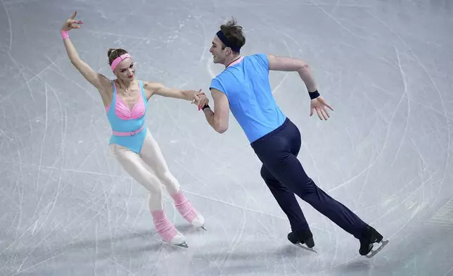 Anastasiia Metelkina and Luka Berulava, of Georgia, compete in the pairs' short program segment at the ISU Grand Prix Finals of Figure Skating, Thursday, Dec. 5, 2024, in Grenoble, France. (AP Photo/Laurent Cipriani)