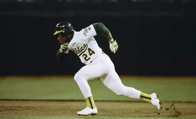 FILE - Oakland Athletics' Rickey Henderson steals second base against the Minnesota Twins in the first inning of a baseball game at Oakland Coliseum in Oakland, Calif., April 10, 1991. (AP Photo/Alan Greth, File)