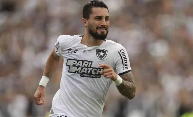 Alex Telles of Brazil's Botafogo celebrates after scoring his side's second goal against Brazil's Atletico Mineiro from the penalty spot during a Copa Libertadores final soccer match at Monumental stadium in Buenos Aires, Argentina, Saturday, Nov. 30, 2024. (AP Photo/Gustavo Garello)