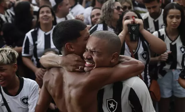 Botafogo soccer fans celebrate a goal scored by Luis Henrique against Atletico Mineiro in the Copa Libertadores title match, broadcast on a giant screen at a watch party at the Nilton Santos Stadium in Rio de Janeiro, Saturday, Nov. 30, 2024. (AP Photo/Bruna Prado)