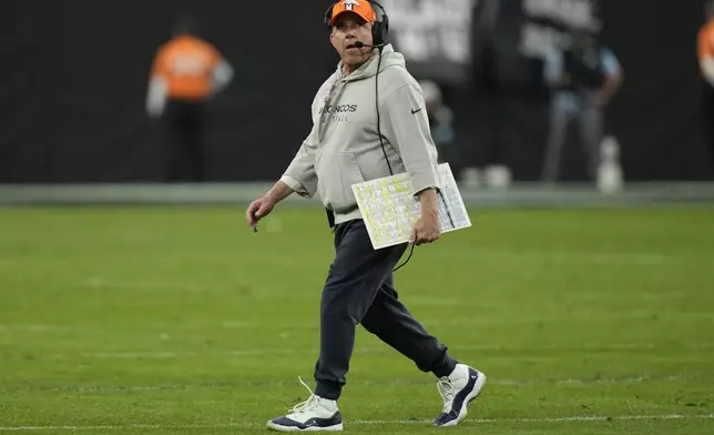 Denver Broncos Head Coach Sean Payton walks on the field during the first half of an NFL football game against the Las Vegas Raiders, Sunday, Nov. 24, 2024, in Las Vegas. (AP Photo/John Locher)