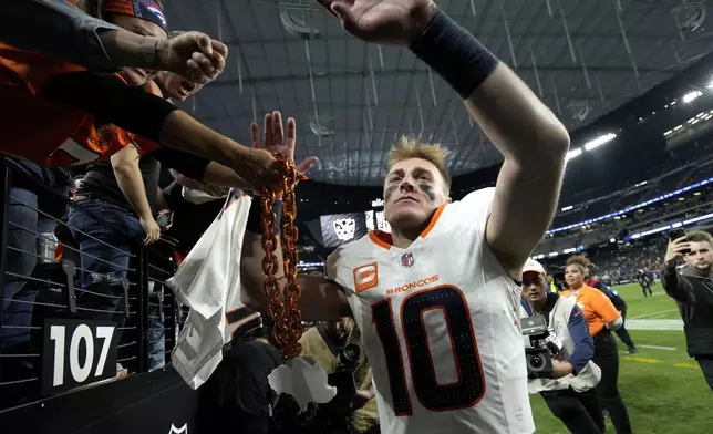 Denver Broncos quarterback Bo Nix (10) greets fans after an NFL football game against the Las Vegas Raiders, Sunday, Nov. 24, 2024, in Las Vegas. (AP Photo/John Locher)