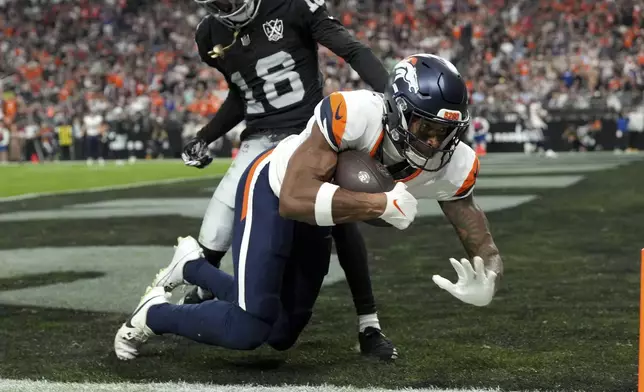 Denver Broncos wide receiver Courtland Sutton pulls in a touchdown pass as Las Vegas Raiders cornerback Jack Jones (18) defends during the second half of an NFL football game, Sunday, Nov. 24, 2024, in Las Vegas. (AP Photo/Rick Scuteri)