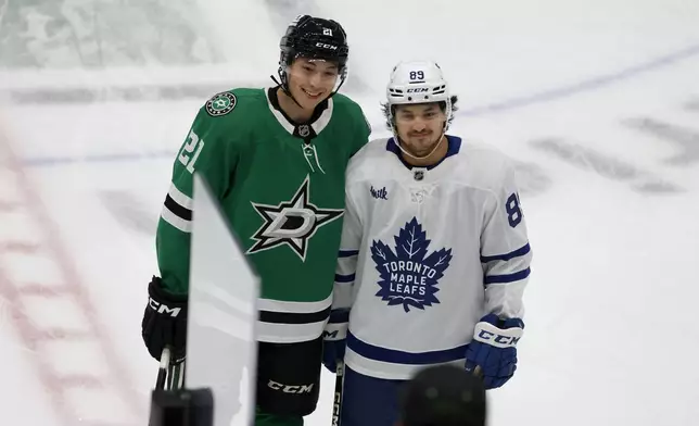 Dallas Stars left wing Jason Robertson (21) and Toronto Maple Leafs left wing Nicholas Robertson (89) pose for a photo prior to an NHL hockey game in Dallas, Wednesday, Dec. 18, 2024. (AP Photo/Michael Ainsworth)