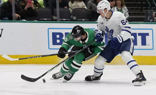 Dallas Stars center Colin Blackwell (15) tries to get past Toronto Maple Leafs center David Kampf (64) during the first period of an NHL hockey game in Dallas, Wednesday, Dec. 18, 2024. (AP Photo/Michael Ainsworth)