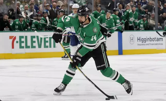 Dallas Stars left wing Jamie Benn (14) takes a shot against the Toronto Maple Leafs during the first period of an NHL hockey game in Dallas, Wednesday, Dec. 18, 2024. (AP Photo/Michael Ainsworth)