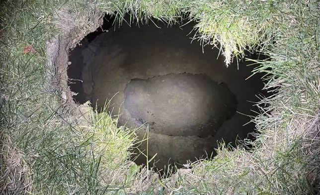 This Tuesday, Dec. 3, 2024. image provided by the Pennsylvania State Police shows the top of a sinkhole in the village of Marguerite, Pa., where rescuers were searching for a woman who disappeared. (Pennsylvania State Police via AP)