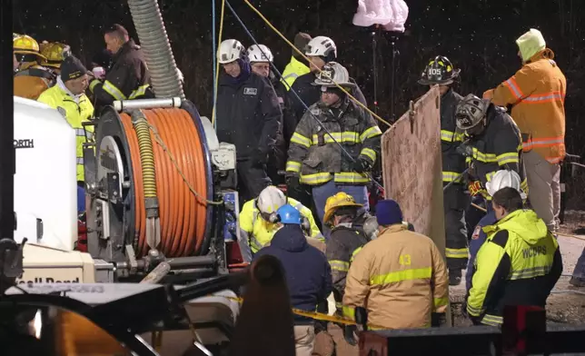 Rescue workers search in a sinkhole for Elizabeth Pollard, who disappeared while looking for her cat, in Marguerite, Pa., Tuesday, Dec. 3, 2024. (AP Photo/Gene J. Puskar)