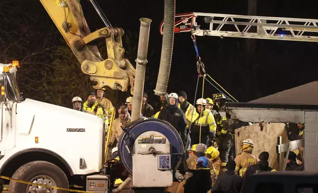 Rescue workers search in a sinkhole for Elizabeth Pollard, who disappeared while looking for her cat, in Marguerite, Pa., Tuesday, Dec. 3, 2024. (AP Photo/Gene J. Puskar)