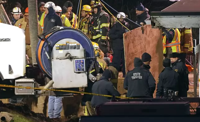 Rescue workers search in a sinkhole for Elizabeth Pollard, who disappeared while looking for her cat, in Marguerite, Pa., Tuesday, Dec. 3, 2024. (AP Photo/Gene J. Puskar)