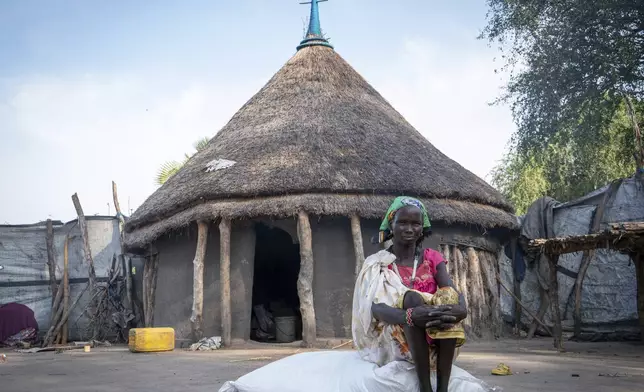 Reat Kuor, mother of eight children sits outside her home in Jonglei state, South Sudan, Wednesday, Nov. 13, 2024. (AP Photo/Florence Miettaux)