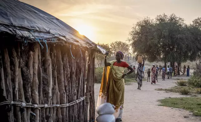 South Sudanese woman takes a break after receiving aid from a food distribution point in Jonglei state, South Sudan, Thursday, Nov. 14, 2024. (AP Photo/Florence Miettaux)