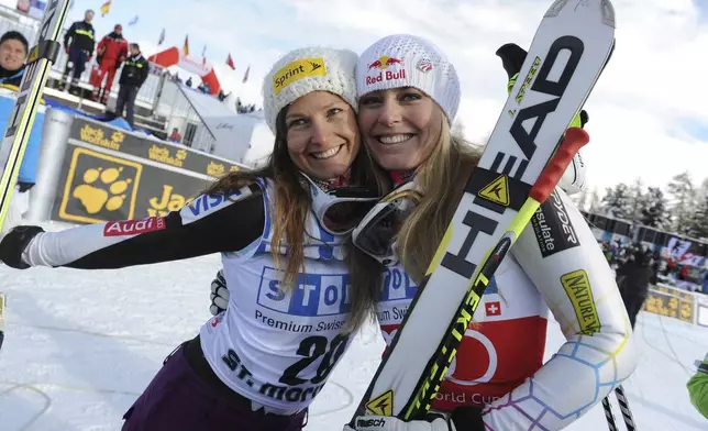 FILE - In this Dec. 8, 2012, file photo, Lindsey Vonn, right, celebrates with third-placed Julia Mancuso after winning an alpine ski, women's World Cup super-G, in St. Moritz, Switzerland. (AP Photo/Giovanni Auletta, File)