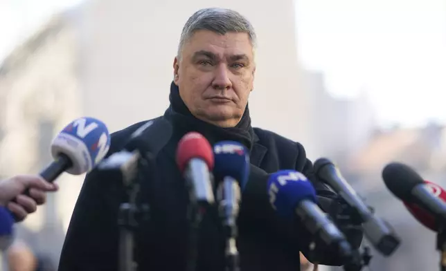 Croatia's President Zoran Milanovic speaks to the media after casting his ballot during presidential elections, at a polling station in Zagreb, Croatia, Sunday, Dec. 29, 2024. (AP Photo/Darko Bandic)