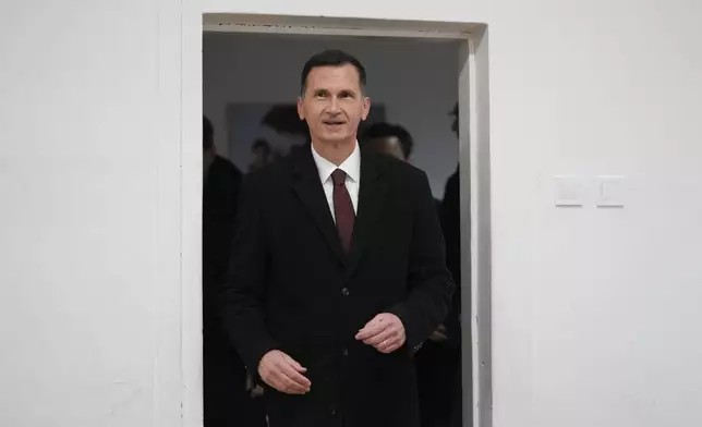 Dragan Primorac, the candidate of the ruling Croatian Democratic Union (HDZ) arrives at a polling station during a presidential election in Zagreb, Croatia, Sunday, Dec. 29, 2024. (AP Photo/Darko Bandic)