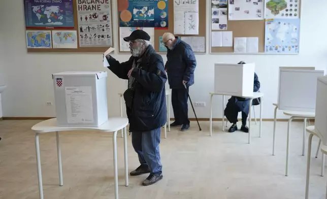 A man casts his ballot during presidential elections, at a polling station in Zagreb, Croatia, Sunday, Dec. 29, 2024. (AP Photo/Darko Bandic)