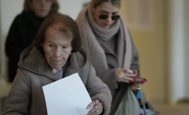 A woman prepares her ballot during a presidential election at a polling station in Zagreb, Croatia, Sunday, Dec. 29, 2024. (AP Photo/Darko Bandic)